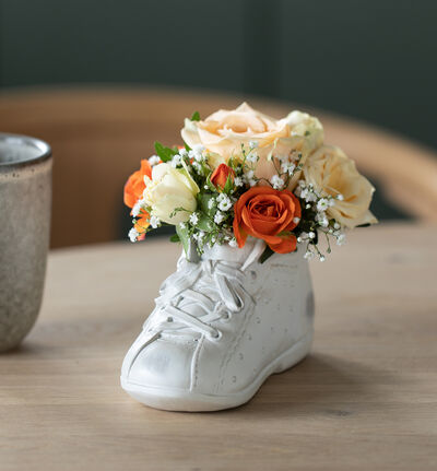 Gylne blomster i babysko med bobler og sjokolade Gylne blomster i babysko med bobler og sjokolade